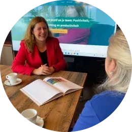Persoonlijke 1-op-1 begeleiding: twee mensen in gesprek over werkgeluk.